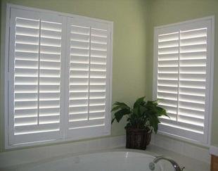 White plantation shutters on a bathroom window